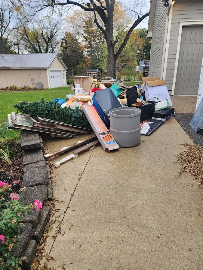 Dumpster being loaded with debris for 12 Yard Dumpster Rental in Spearfish